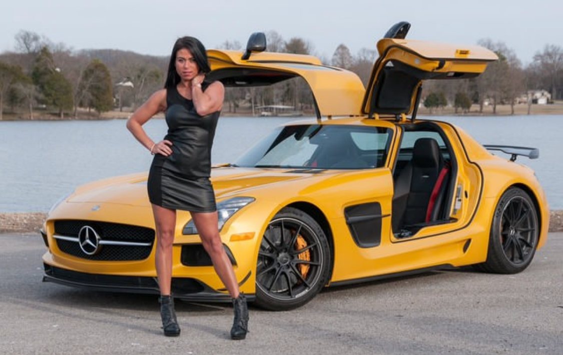 Natalie Nicole posing with a sports car